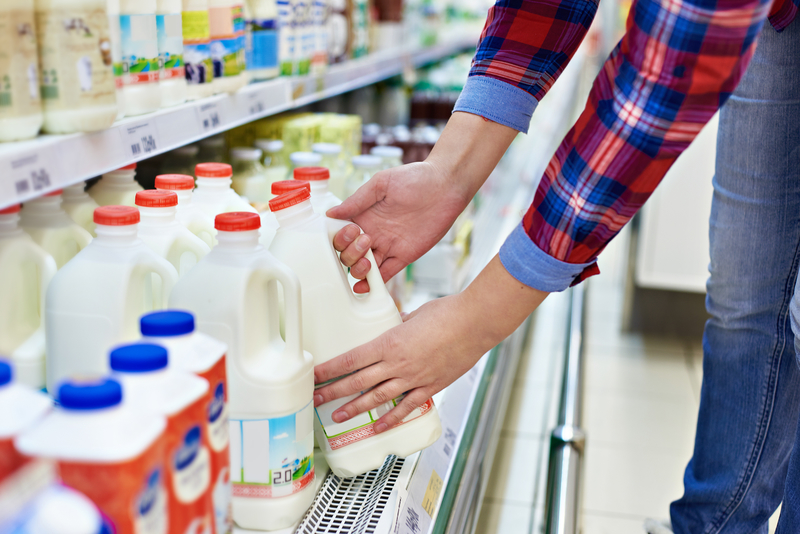 Woman shopping milk in store Woman shopping milk in store