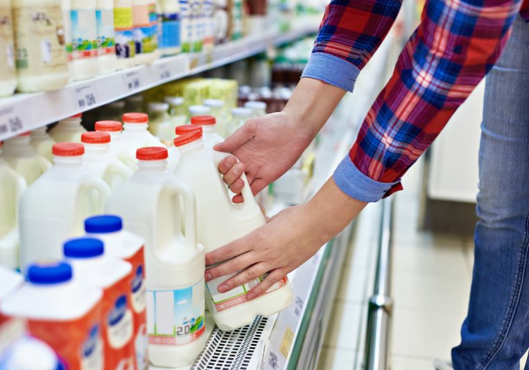 Woman shopping milk in store